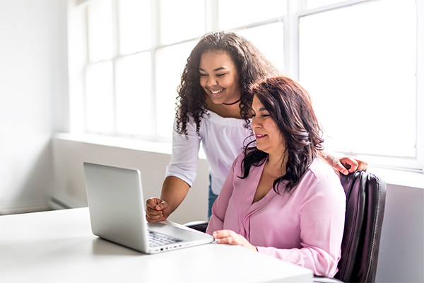Two students looking at a computer screen
